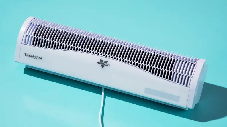 Our pick for best overall window fan, the Vornado Transom AE, floating on a blue background.