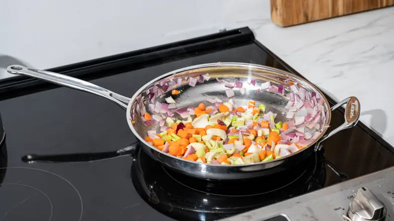 The Cuisinart Chef's Classic Stainless Steel skillet is filled with vegetables.
