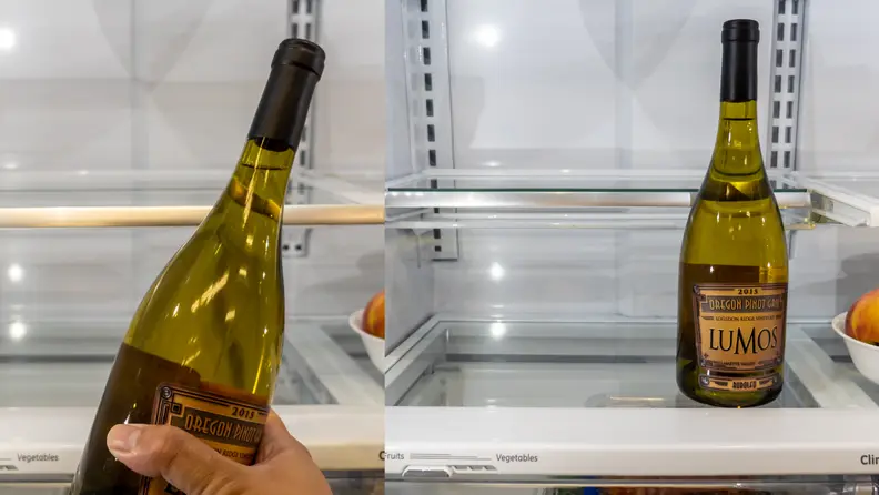 A wine bottle is too short for a shelf and then it stands on a shelf