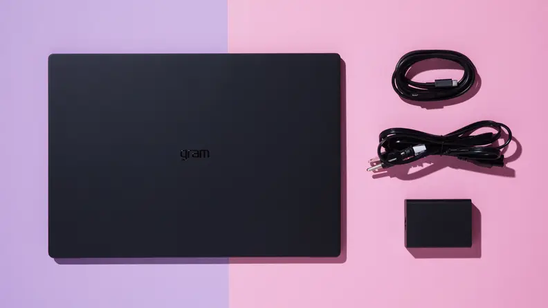 The LG gram Pro 17 laptop next to two USB cord and charging cube.