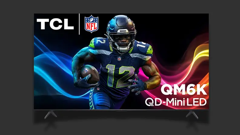 A TV with a colorful screen sits on a black background