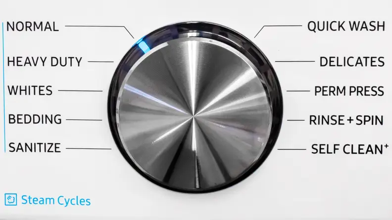 The plain, metallic control dial on the Samsung WF45R6100AW washer. Arranged around it are all the different cycles you can select.