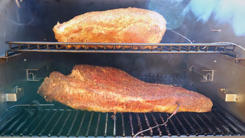 Brisket smokes on a pellet grill.