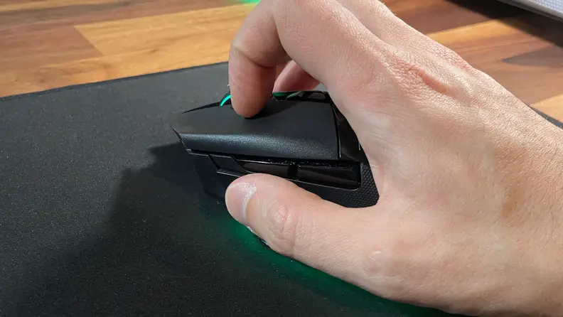 A hand holding the mouse.