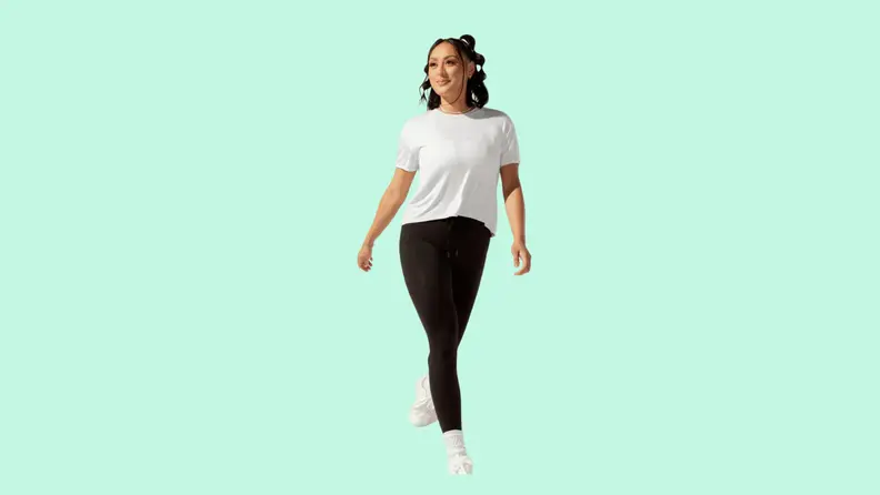 A model wearing black tights and a white T-shirt.