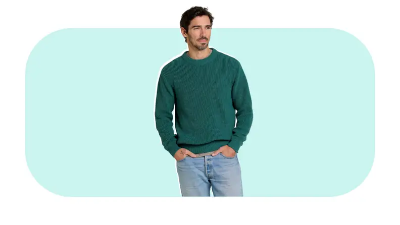 A model wearing a green sweater.