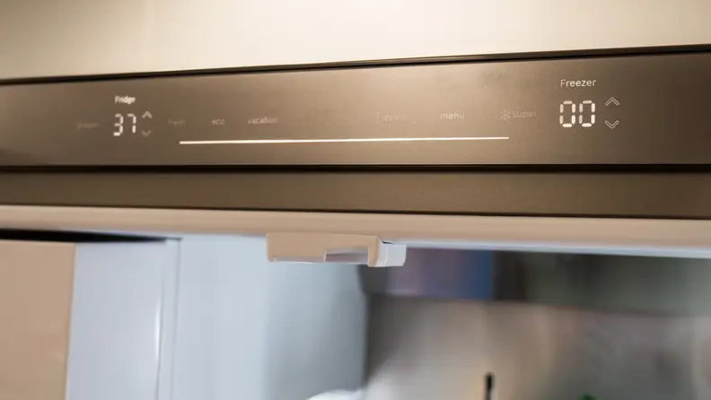 A close-up of the Bosch B36CD50SNS French-door fridge's touch button controls. They have a matte stainless steel look, and the LEDs underneath are seamlessly integrated.