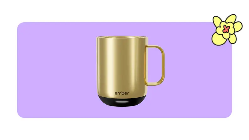 Product shot of gold Ember tumbler mug in front of a purple background with a yellow cartoon flower.