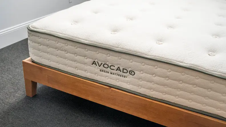 The Avocado mattress on a brown bed frame