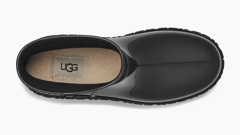 A black Ugg rain boot shot from above, showing off the fluffy inside