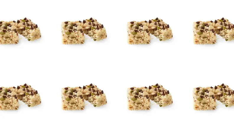 A repeating pattern of seed-filled chocolate chip rice crispy treats.