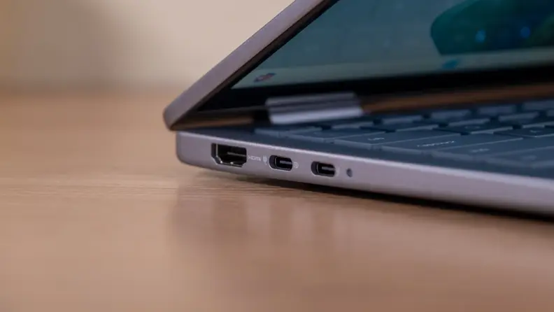 A closed silver laptop sits on a brown desk