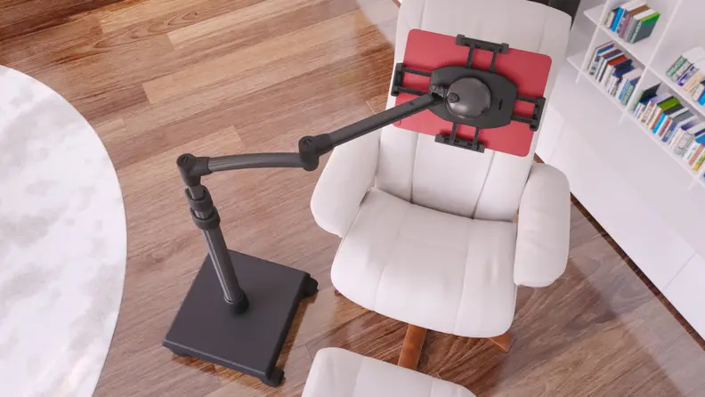 Tablet stand hanging over arm chair and foot rest