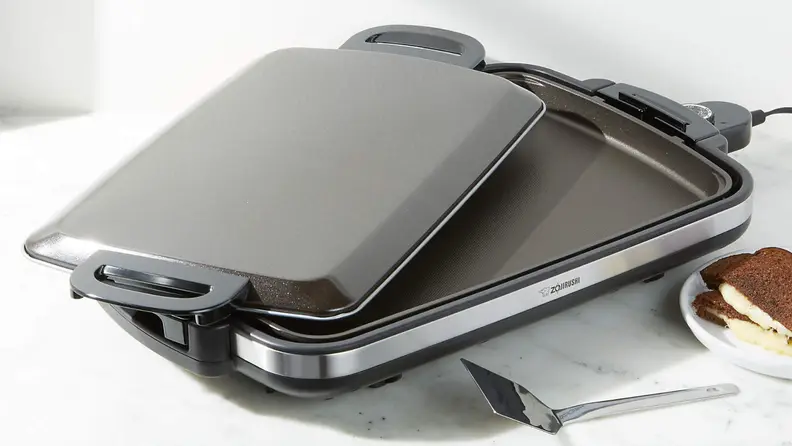 Zojirushi Gourmet Sizzler and lid on white surface
