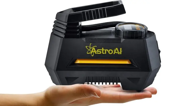 Compressor in person's hand against white background