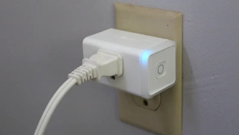 The Kasa Matter Smart Plug with Energy Monitoring plugged into an electrical socket