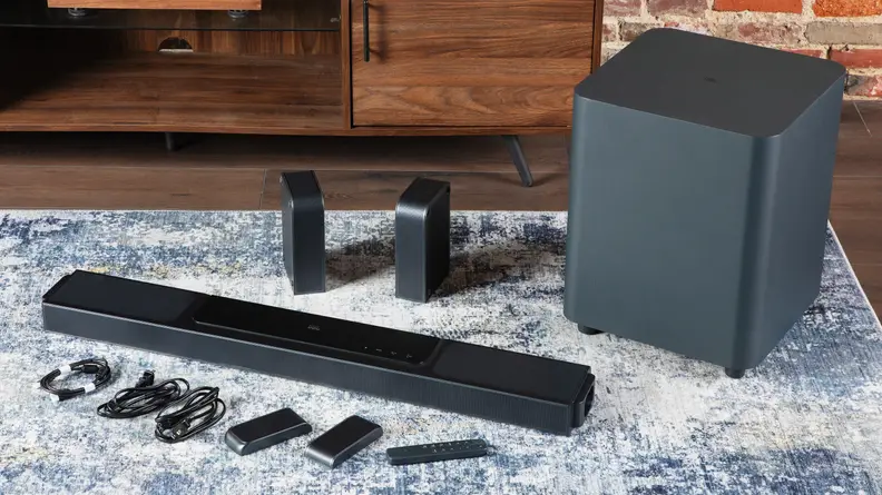 The JBL Bar 1300X pieces laid out on a carpet.