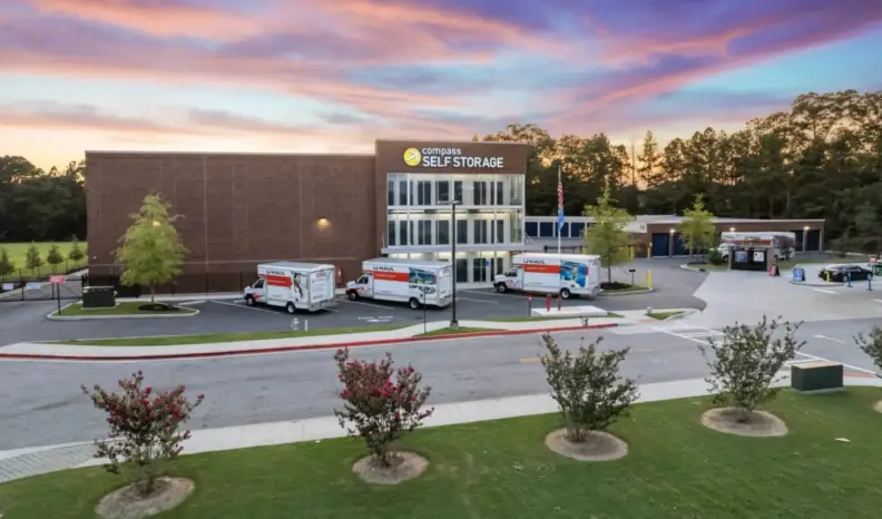 A large self-storage facility and hauling trucks parked out front