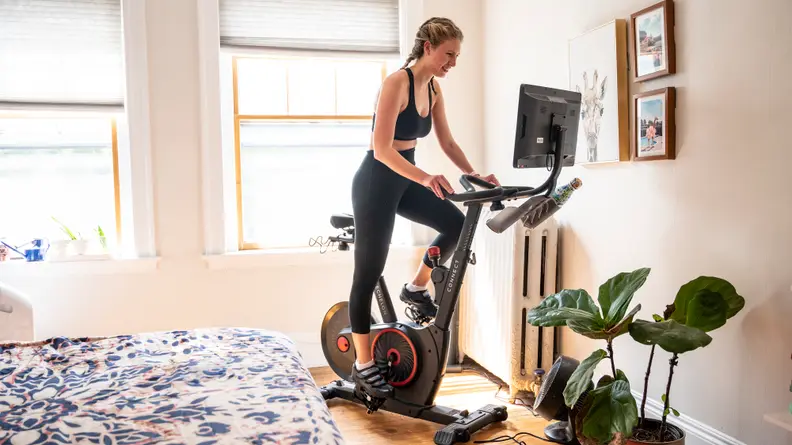 A person works out on the Echelon stationary bike in their bedroom.