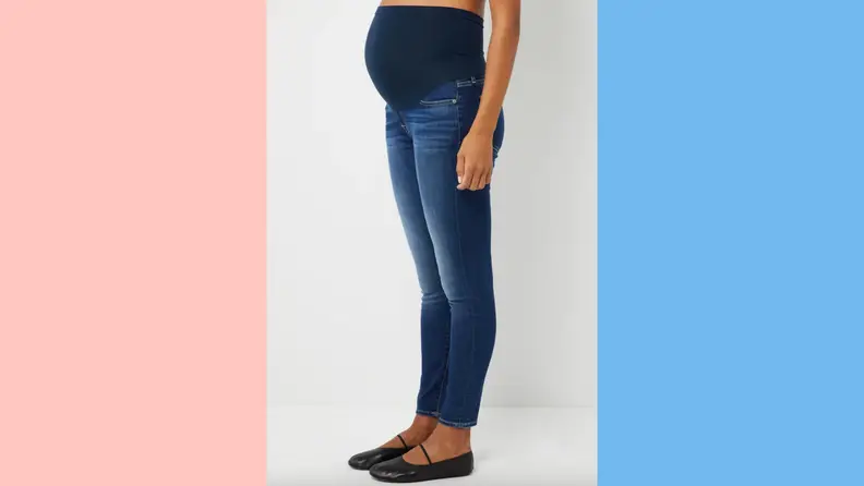 A pregnant woman wearing jeans from A Pea in the Pod.