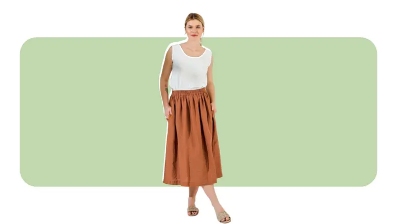 A model wearing a dirndl-style midi skirt in orange.