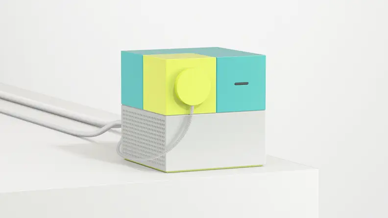 The cube-like Nex Playground device on a gray background.