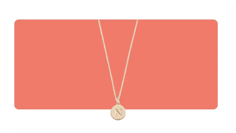 A gold Kate Spade Alphabet Pendant necklace with the letter "N" on the pendant.