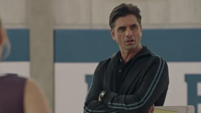 A screenshot from the series Big Shot featuring Jon Stamos glowering.