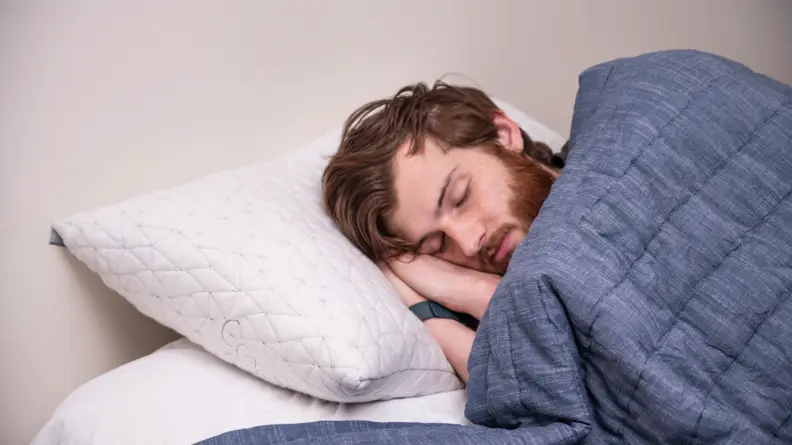 a man sleeps on the coop home goods pillow