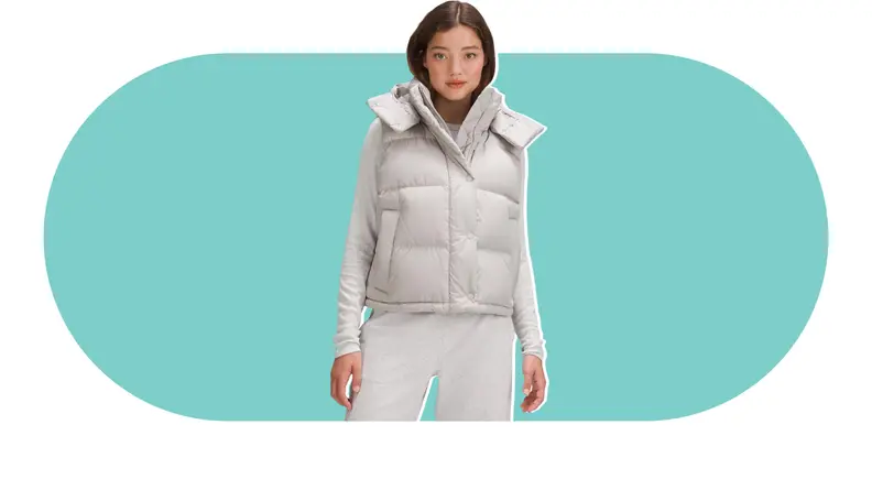 A model wearing a gray puffer vest.