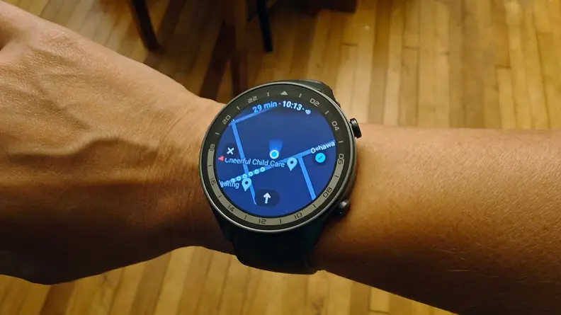A hand with the watch on its wrist displaying general directions in Google Maps.