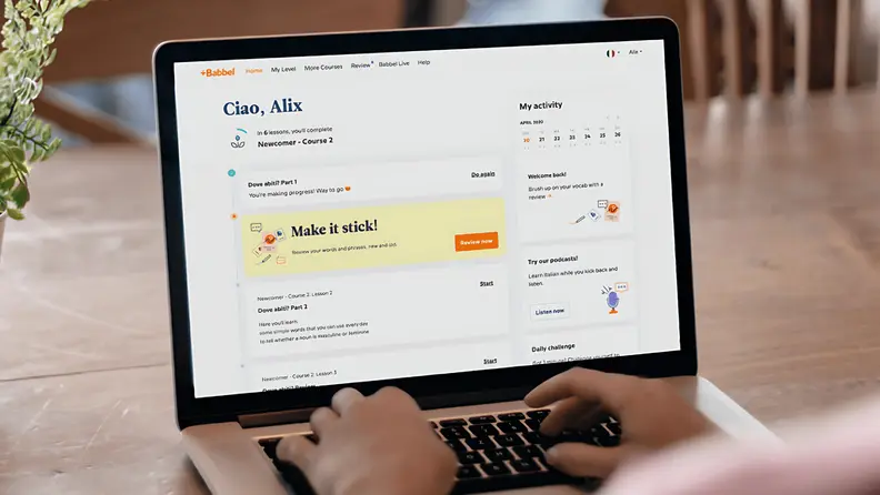A person pulls up a Babbel page with the learning summary on a laptop