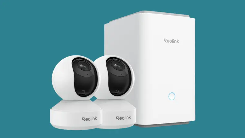 A white security camera on a teal background