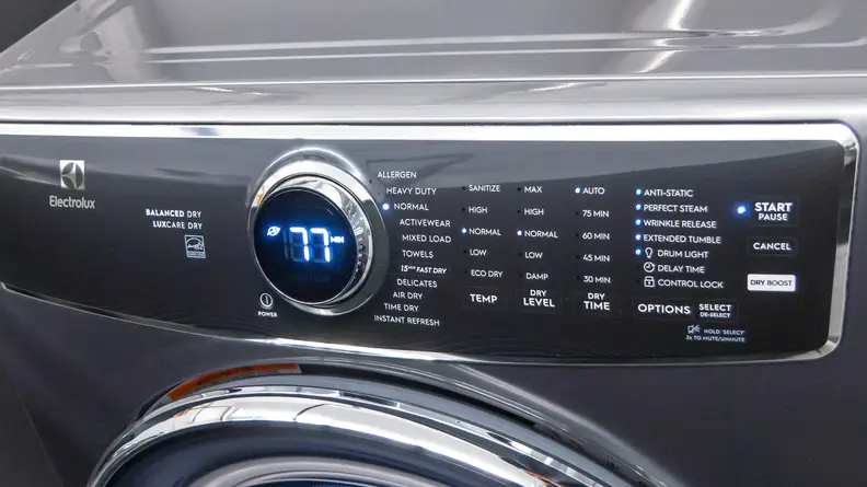 The image shows a dryer’s black interface with white lettering and a round dial in the center that has the number 77 on it.