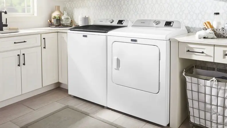 White washer/dryer set in a light, clean laundry room.