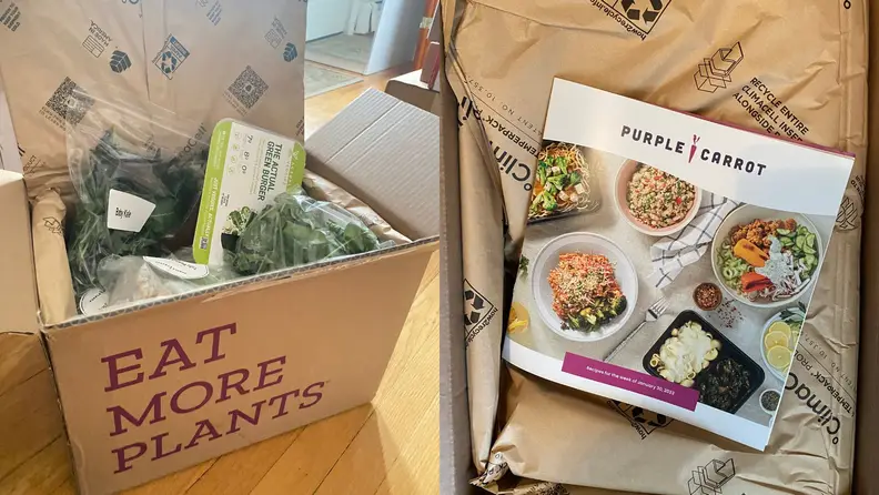 An opened box with meal packaging inside.
