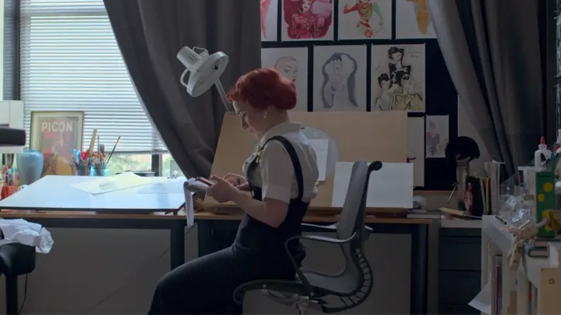 A still from the series Inside Pixar featuring one of the artists at her desk.