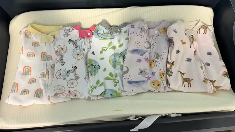 Burt's Bees Baby clothes folded next to each other.
