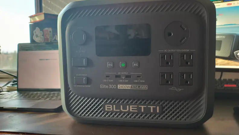 Elite 300 sits on a wooden desk with screen off
