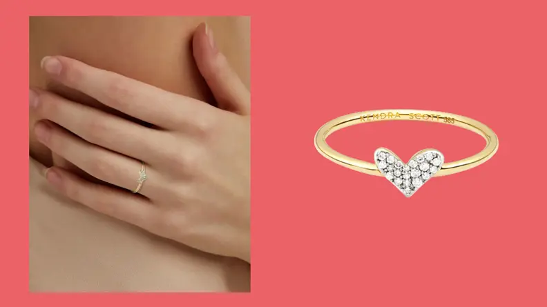 A delicate Kendra Scott gold ring in with small white diamonds in the heart shaped symbol.