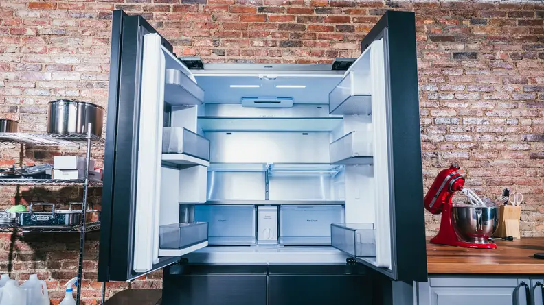A large French door fridge stands with its doors wide open