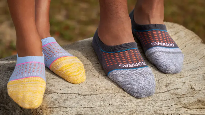 Two people wearing Bombas no-show socks