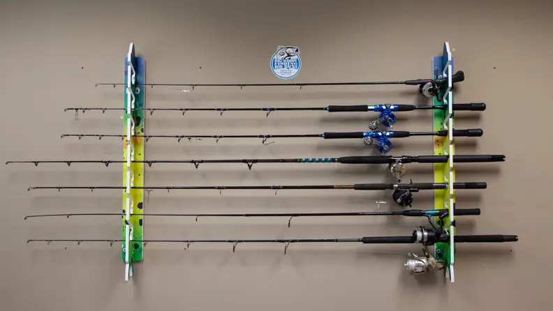 A set of fishing rods sitting on a fishing rod rack horizontally