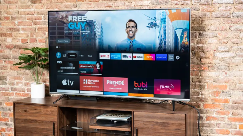 The Amazon Fire TV Omni displaying its smart platform's home screen in a living room setting