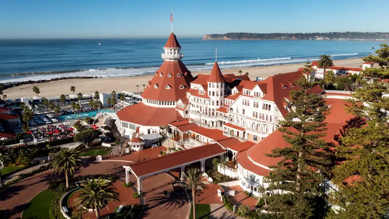 A turreted hotel sits on a beach