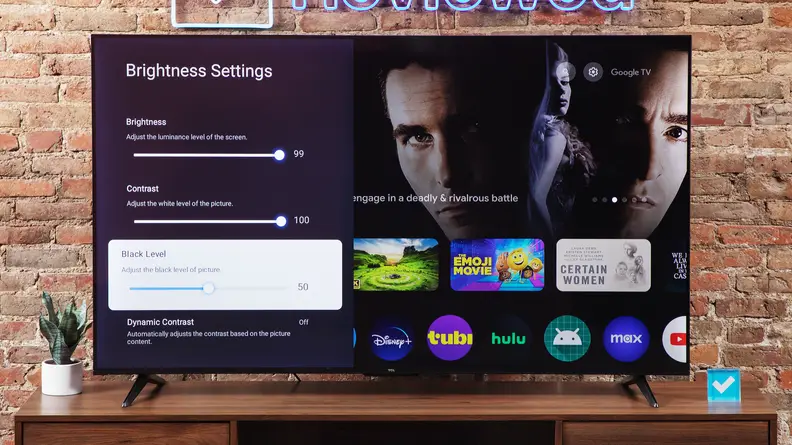 The TCL S4 LED TV on a wood entertainment center with a brick background.