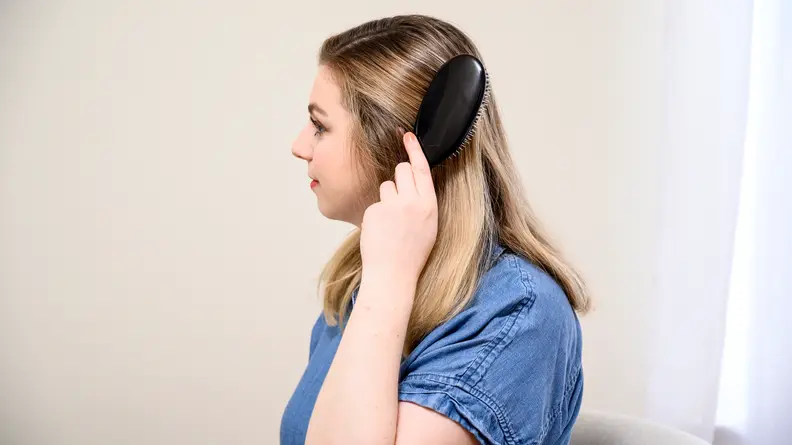 A photo of the author using the Mason Pearson hair brush.