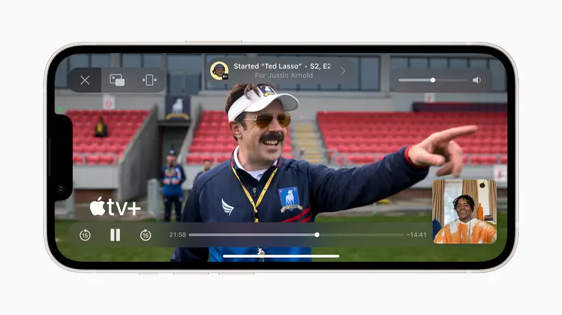 An iPhone in landscape, showing a scene from the Apple TV+ show Ted Lasso.