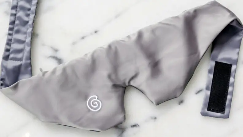 a gravity mask resting on white marble counter top