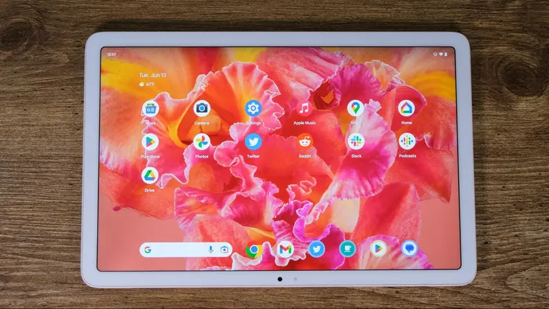 A Pixel tablet sits on a table. It's turned on and it's app interface is just waiting to be used.
